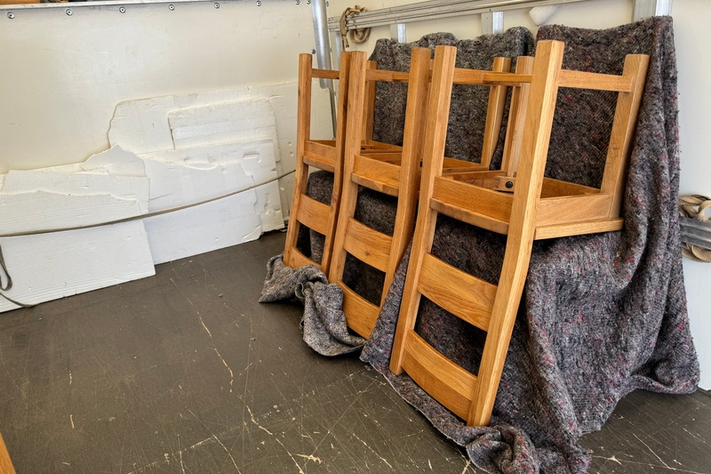 Chairs in a delivery van, protected by a blanket